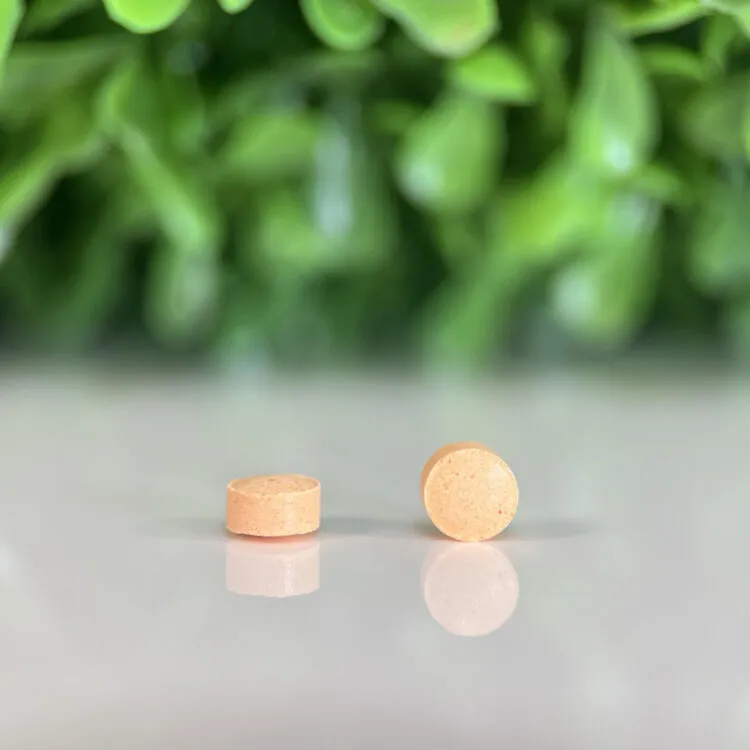 Gabapentin 50 mg mini-tablets compounded for dogs and cats, small orange tablets on reflective surface