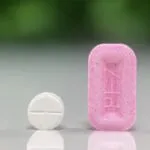 Pimobendan Quad-Mini Tablet next to a pink PEZ candy for size comparison